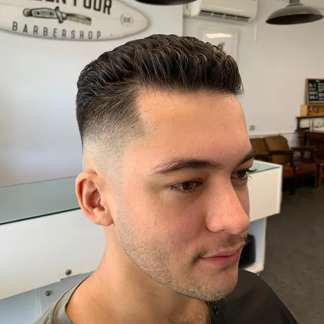 Clean short fade and textured top at Golden Four