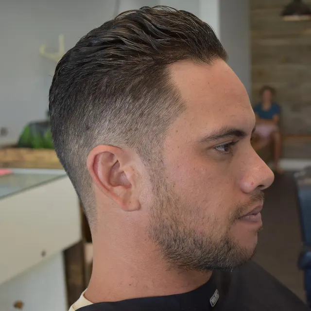 Brushed-back haircut with a tidy beard at Golden Four