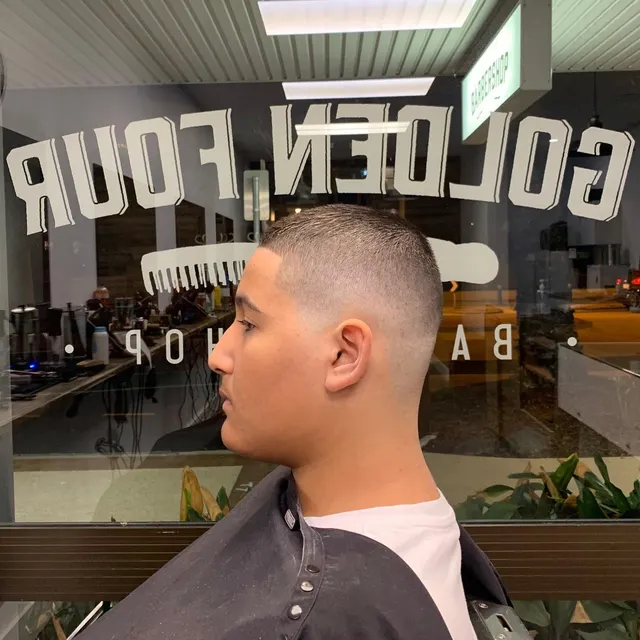 Close-cut fade by the shop window at Golden Four