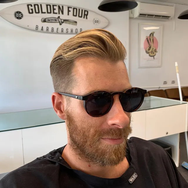 Longer swept-back style and beard at Golden Four
