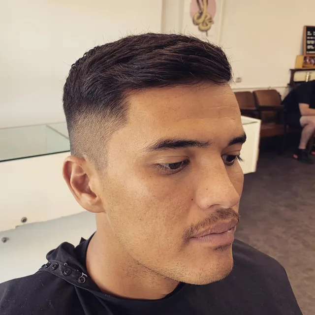 Short textured dark haircut at Golden Four