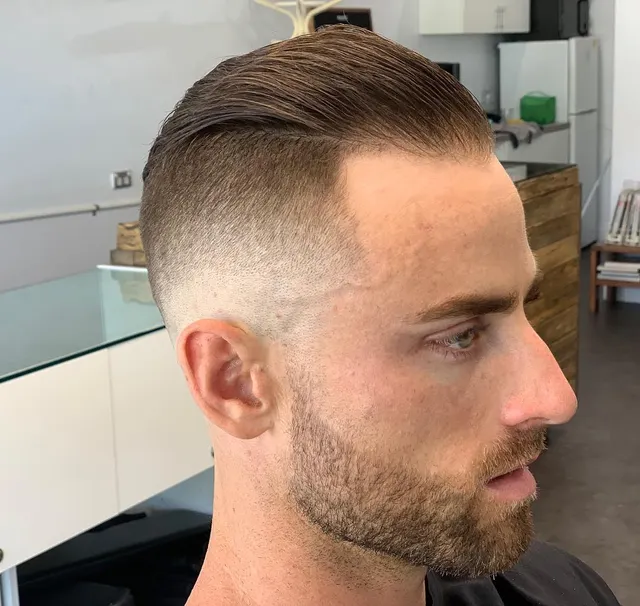 Slicked-back cut with defined sides at Golden Four